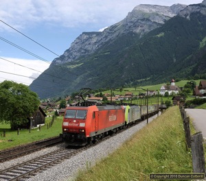 DB 185.106 piloted BLS 486.507 south from Erstfeld with an intermodal train on 17 June 2010. The train was photographed at Silenen when there was some unfamiliar blue stuff between the clouds.