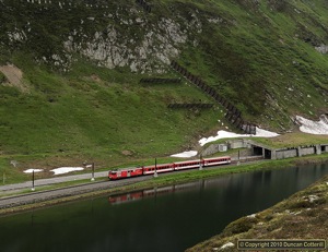 Ex BVZ Motor Luggage Van No.24 had just emerged from the avalanche shelter at the summit of the Oberalp Pass and was running alongside the Oberalpsee with train 831, the 09:14 from Disentis to Andermatt on 19 June 2010. 