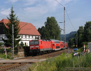 The Elbe Valley line is unusual in being scenic and having a good local train service. S-Bahn line 1 trains run to Bad Schandau every half hour and many continue to Schöna, right on the Czech border. 143.875 led train 7027 eastwards towards Königstein on 22 July 2010.