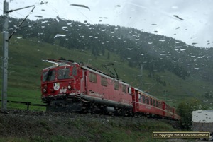 It wasn't all sunshine and blue skies. 607 worked RE1325 up the Engadin near S-chanf during a downpour on 28 August 2010.