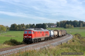 233.511 worked the afternoon freight north from Hof to Reichenbach on 8 October 2010. The train was photographed on the curve north of Grobau.