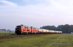 225.805 and 225.010 were photographed between Pirach and Lindach, west of Burghausen, with a train of empty gas tanks late on the afternoon of 13 October 2010.