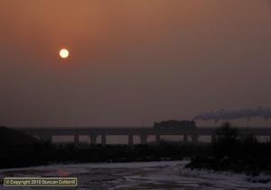 The main river bridge at Qiaonan was one of the few locations on the Chengzihe system that hadn't been poled. An unidentified SY trundled back towards Dongchang for the shift change on 2 December 2010.