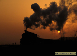 SY 1210 returned to Wulong Mine from the spoil tips as the sun dropped into the murk on 4 December 2010.