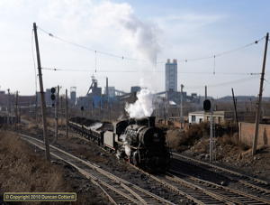 SY 1378 emerged from Wulong Mine with a train of spoil on 5 December 2010. The loco would run forward onto a stub of the former line into the opencast mine then reverse its train up the line on the left to the tips.