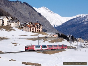 Locos of class Ge6/6ii used to appear regularly on passenger trains but are a bit of a rarity these days. The only working during my trip was on 19 February 2011 when 704 worked RE1335 from Landquart to St. Moritz and RE1350 back. The loco was photographed east of Madulain with RE1335, composed entirely of Panoramawagen.