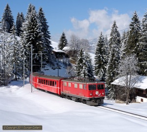 610 approached Cavadürli with train 823, the 11:44 Klosters Dorf - Davos Platz Sportzug, on 23 February 2011.