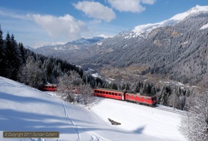 With the Prättigau spread out behind, 610 climbed towards Cavadürli with 831, the 13:44 Klosters Dorf - Davos Platz on 23 February 2011.