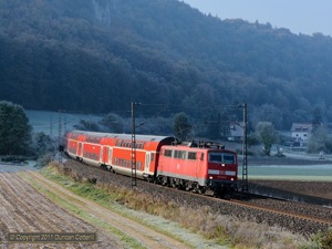 111.034 emerged from the shadows at Breitenfurt, east of Dollnstein, with RB59147, the 08:39 from Nürnberg Hbf to München Hbf, on 23 October.