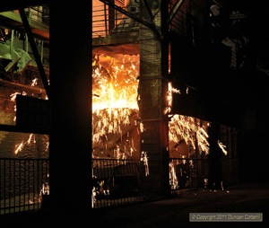 A fireworks display under the furnaces as molten iron cascaded into a waiting ladle.