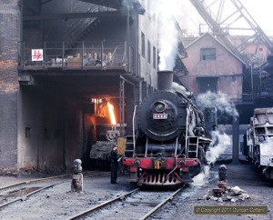 SY 0448 waited in the shadow of the blast furnaces while its slag ladles were filled.