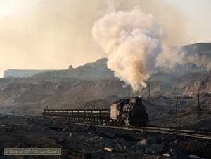 Looking more wild west than mystic east, JS 8078 hustled a loaded coal train along the northern side of the pit at Sandaoling in glorious evening light. 