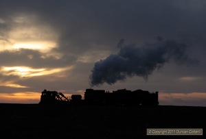 JS 8194 went to work at sunset, pushing a Jordan spreader onto the spoil tips at Xibolizhan.