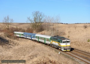 754.045 rounded the big curve east of Brankovice with Os4145, the 14:47 from Brno hl.n. to Nemotice, on 24 March 2011. 