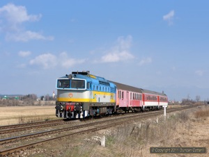 750.300 hauled Os7303, the 11:06 Vrutky - Zvolen, south towards Jazernica on 28 March 2011. Zvolen depot keeps a number of its locos in immaculate condition. 