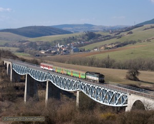 754.073 crossed the middle of the three viaducts west of Hanusovce nad Toplou with Os9111, the 15:00 from Presov to Humenne, on 3 April 2011.