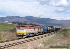 751.171 and 751.123 approached Jovice with a westbound freight on 7 April 2011, narrowly missing the shadow of a marauding cloud.