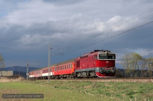 The storm clouds were approaching as 754.054 passed Velka Luka with Zr1843, the 15:16 from Zilina to Zvolen, on 8 April 2011.