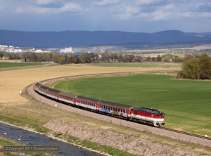 The line between Kos and Novaky has recently been diverted around an area of mining subsidence. 750.110 headed south along the new line with R720, the 16:36 from Prievidza to Bratislava, on 9 April 2011.