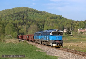 753.776 and 753.780 headed a train of empty car-carriers southwards on the afternoon of 29 April 2011. The train was photographed north of Oldrichov v Hajich.