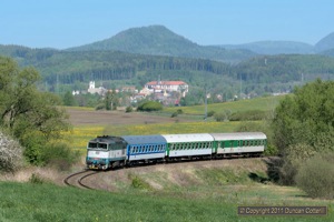 The only booked diagram for a class 750 on passenger trains involves two return workings a day on fast trains between Liberec and Usti nad Labem. 750.118 attacked the climb from Zakupy to Mimon with eastbound train R1157 on the morning of 1 May 2011. In the background the village of Zakupy nestled in the green hills.