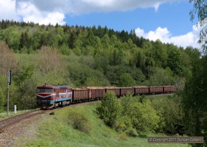 751.149 approached Lipova Lazne with a loaded timber train from the Javornik ve Slezsku branch at lunchtime on 16 May 2011.