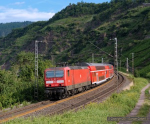 The shadows were just clearing as 143.009 emerged from the Petersberg tunnel at Neef with RE12008, the 08:22 Koblenz Hbf to Saarbrücken Hbf passenger, on 7 July 2011.