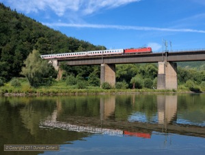 An unidentified 181, probably 181.204 judging by the shiny paintwork, led IC133, the 08:22 Luxembourg - Koblenz IC, over the bridge at Ediger-Eller on 10 July 2011. 