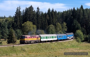 The second of the day's loco hauled workings, Os8109/8108, the 08:07 Ceske Budejovice - Nove Udoli passenger, hauled by 749.100, crossed a forest clearing, less than 1km from the terminus at Nove Udoli on 11 August 2011.