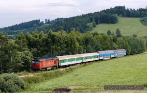 749.252 approached Horice na Sumave with Os8113/8112, the 10:07 Ceske Budejovice - Nove Udoli passenger, in half sun on 12 August 2011.