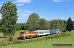 This superb position west of Nova Pec isn't as pleasant as it looks. The area is close to wetlands on the banks of the Vltava River and infested with hungry mosquitos. It was worth sacrificing some blood to get this shot of 749.100 heading for Nove Udoli with Os8121/8120, the 14:07 stopper from Ceske Budejovice, on 12 August 2011.