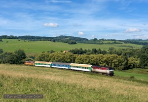749.254 dragged Os8111/8110 back towards Ceske Budejovice on 14 August 2011. On the rear was a dead 749.100 which had failed earlier on the outward journey with Os8105/8104. The photo was taken east of Horice na Sumave station, just visible above the second coach.