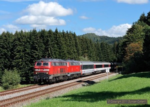 218.445 and 218.463 combined to head EC194, the diverted 12:34 München - Zürich, westwards on the afternoon of 9 September 2011. The train was photographed emerging from the woods between Harbatshofen and Heimhofen.