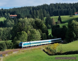 223.066 led five coach westbound ALX84150, the 15:19 from München to Lindau, out of the shadows near Harbatshofen late on the afternoon of 9 September 2011.
