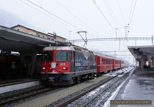 Scuol-Tarasp - Pontresina trains are normally worked by push-pull sets in push mode but on 5 March 2012, train 1921 was formed of 619 hauling three coaches. The photo was taken at Samedan as the rain turned to snow. 