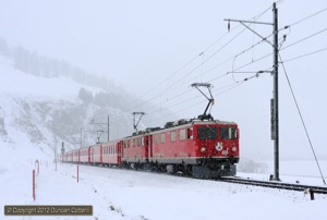 610 and 603 approached Celerina with RE1125, the 08:58 from Chur to St.Moritz, as the snow fell on 5 March 2012. The pair had taken over from a Ge4/4iii at Samedan. 