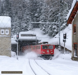 707 kicked up the snow as it emerged from the Albula Tunnel at Preda with Pontresina - Landquart freight 5140 on 5 March 2012. 