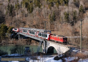 605 worked the Glacier Express from Chur to Disentis and back on 9 March 2012. The train was photographed crossing the Vorderrhein west of Reichenau-Tamins on the return leg.