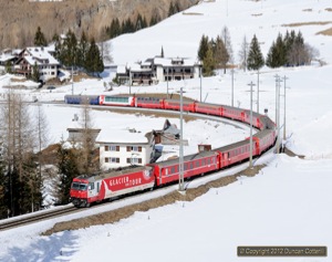 Glacier Express liveried 651 climbed away from Bergün with RE1137 from Chur to St.Moritz on 10 March 2012.