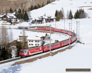 Glacier Express liveried 651 climbed away from Bergün with RE1137 from Chur to St.Moritz on 10 March 2012.