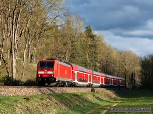 RE services from Singen to Stuttgart are worked by class 146.2 electrics. 146.218 passed Dettingen, south of Horb, with RE19048 on the evening of 20 April 2012.