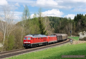 Engineering work on the main line between Regensburg and Nürnberg caused a number of freights to be diverted via Schwandorf and Hersbruck. 232.252 descended the bank from Etzelwang with a westbound van train on 25 April. Electric loco 185.388 was still attached to the train.