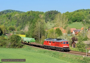 232.675 climbed past Penzenhof with train 56906, the morning Nürnberg - Schwandorf freight, on 4 May. The green tanks are domestic waste containers, bound for the incinerator at Schwandorf.