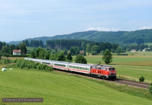 Ulm's 218.326 was photographed hauling IC2084, the 09:26 Oberstdorf - Augsburg, north at Immenthal, near Günzach on 21 June. In a few minutes the train would reach the top of the Günzacher Steige, the summit of the line at just over 800m above sea level.