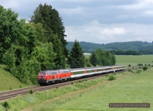 Diverted EuroCity EC194, the 12:11 München - Zürich, approached Görwangs, west of Aitrang, between Biessenhofen and Günzach, behind 218.444 and 218.433 on 22 June.