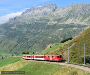 Only a few km from the Gotthard but a world away from the the continuous parade of heavy freight trains and the incessant drone of traffic on the Autobahn, an MGB train climbed out of Andermatt towards the summit of the Oberalppass. Deh4/4i motor luggage van 55 led train 832, the 11:27 Andermatt - Disentis/Mustér, up the rack section towards Nätschen on 3 September 2012. The gradients on this section reach 1 in 9!
