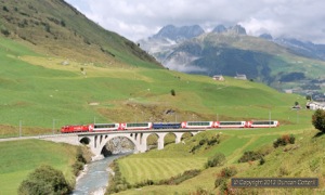 The last of four sections of the westbound Glacier Express, train 911 from Davos Platz to Zermatt, crossed the Furkareuss west of Hospental behind HGe4/4ii No. 4 on 3 September 2012. A fine old RhB dining car has been substituted for the usual modern vehicle. 