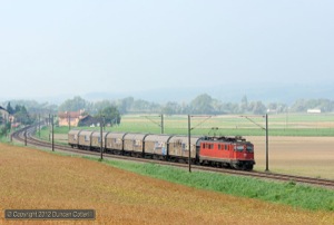 It took a long time for the morning mist to clear on 6 September 2012. Ae6/6 11464 passed Essert-Pittet with train 61535, the 08:45 Lausanne Triage - Estavayer-le-Lac vans as the sun started to break through.