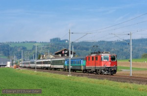 The most interesting passenger trains on the Olten - Luzern route are the 2-hourly Basel - Locarno IR services, which can be worked by Re4/4iis or 460s and often contain coaches in a variety of liveries. 11131 led IR2169, the 10:04 departure from Basel SBB, east from Nebikon on 5 October 2012.