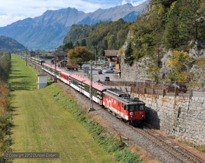 Brünig IR services are booked to cross at Brienzwiler where 110.021 was photographed leading IR2225 away from the station on 6 October 2012. In the background, 110.022 restarted westbound IR2224. 